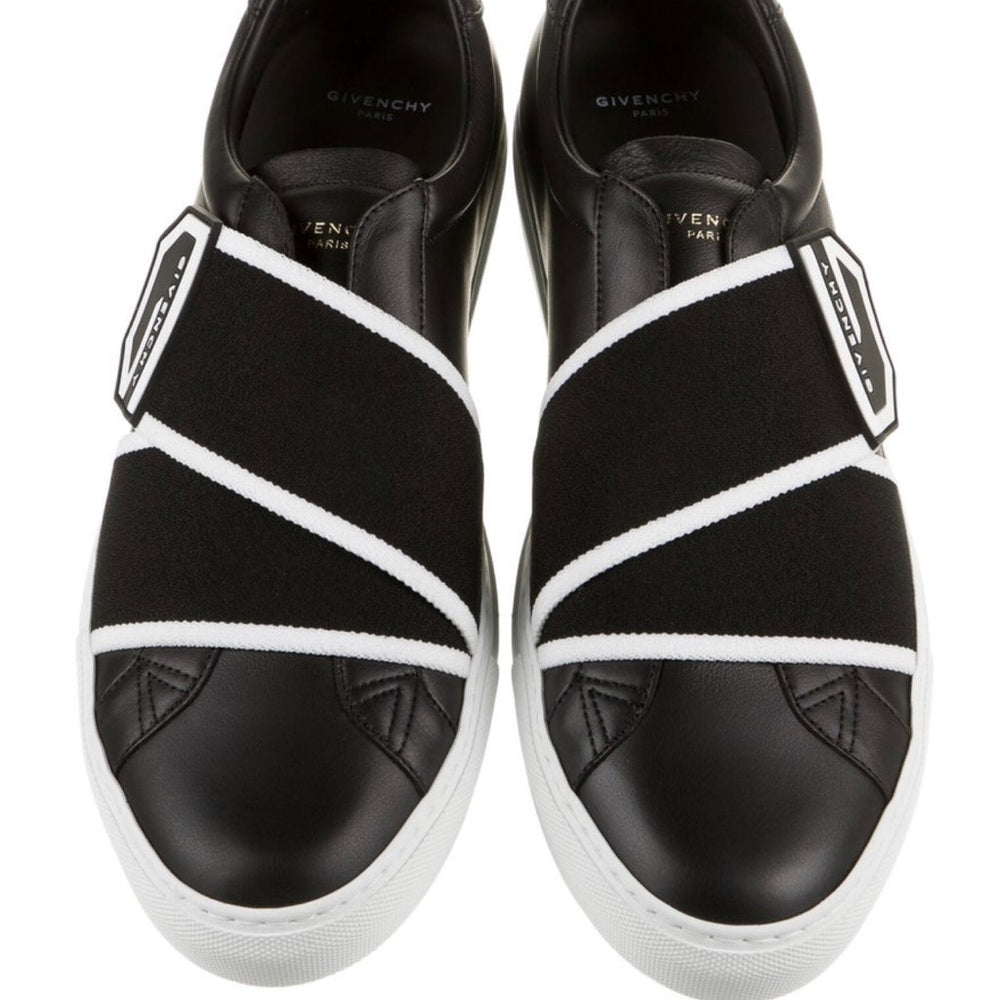 Givenchy leather slip-on sneakers.Round toes. Velcro closure at uppers.